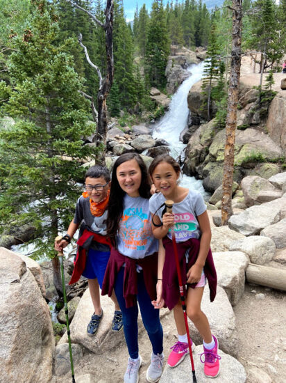 3 kids in front of waterfall
