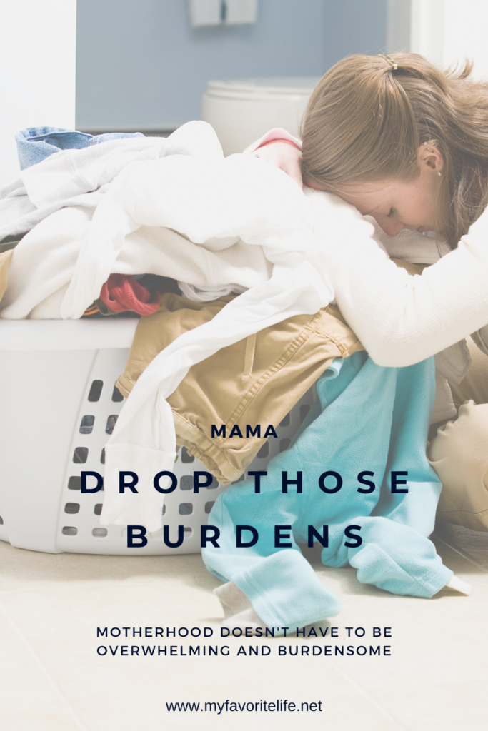 Mom leaning her head over a pile of dirty clothes