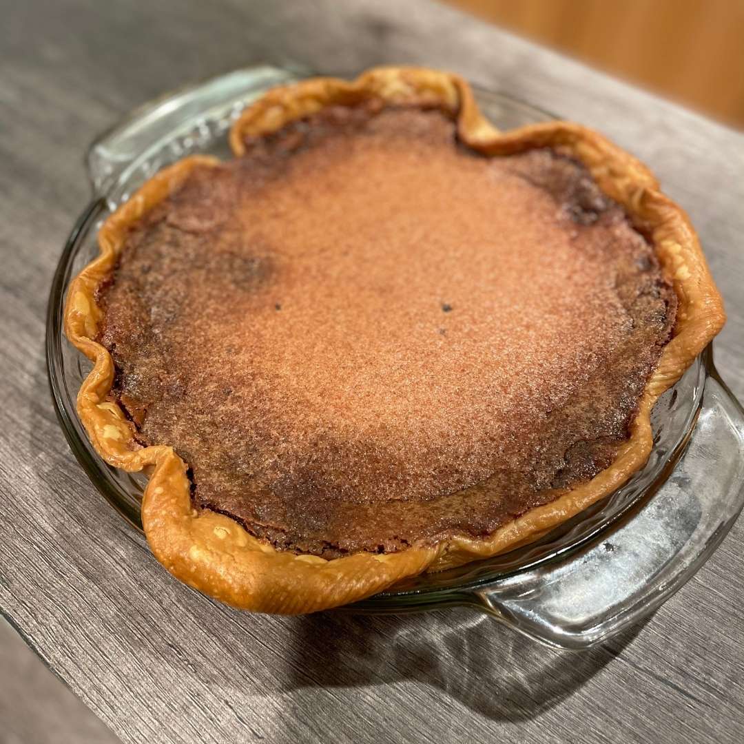 Photo of chocolate chess pie in wood board
